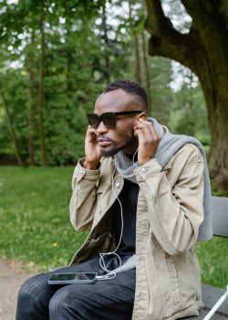 A man with visual disability listening to music